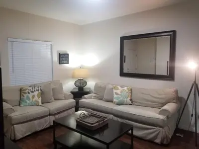 a living room with two couches and a mirror at 3 Bed 2 Bath Condo in Lucaya Village Near Disney townhouse in Kissimmee