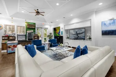 a living room with a white couch and blue chairs at 3 Bed 2 Bath Condo in Lucaya Village Near Disney townhouse in Kissimmee