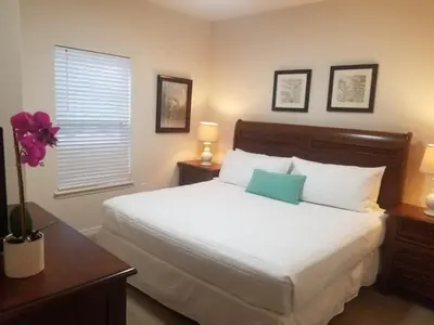 a bedroom with a large white bed and a window at 3 Bed 2 Bath Condo in Lucaya Village Near Disney townhouse in Kissimmee