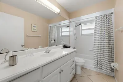 a white bathroom with a sink and a toilet at Ultimate Resort Gateway in Orlando