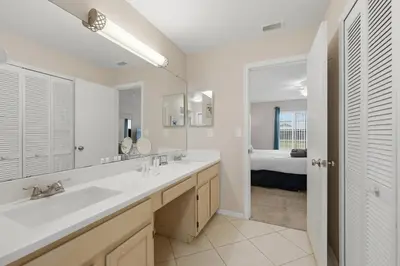a bathroom with a sink and a large mirror at Ultimate Resort Gateway in Orlando