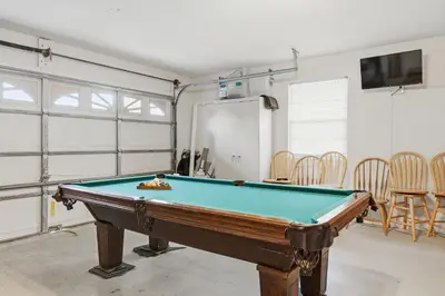 a room with a pool table in a room with chairs at Ultimate Resort Gateway in Orlando