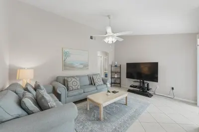 a living room with a couch and a tv at Ultimate Resort Gateway in Orlando
