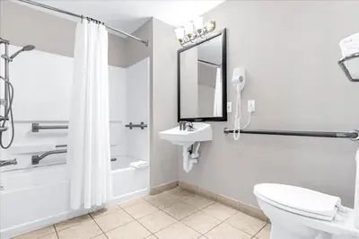 a bathroom with a shower toilet and a sink at Condo with Hot Tub and Pool - Near to Disney in Orlando