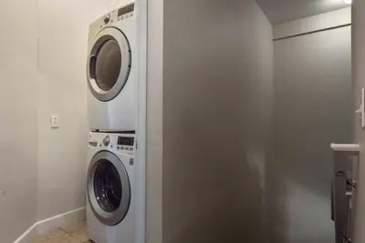 a washer and dryer in a small bathroom at 4 Bedrooms 3 Bathrooms Lucaya Village townhouse in Kissimmee