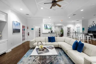 a living room with a white couch and blue pillows at 4 Bedrooms 3 Bathrooms Lucaya Village townhouse in Kissimmee