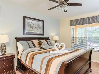 a bedroom with a bed and a ceiling fan at Southern Comfort Private Pool Spa Near Disney! villa in Kissimmee