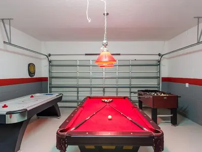 a room with a pool table and two billards at Southern Comfort Private Pool Spa Near Disney! villa in Kissimmee