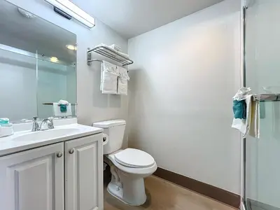 a bathroom with a toilet and a sink and a shower at Stayable Kissimmee East in Kissimmee