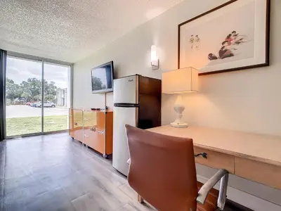 a office with a desk and a refrigerator at Stayable Kissimmee East in Kissimmee