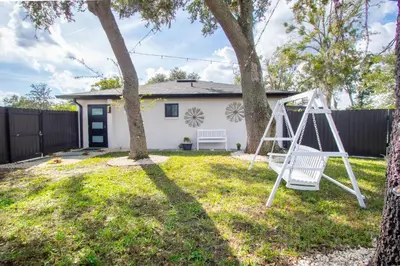 a swing in a yard with a house at Longwood Private Suite - Near Orlando - Modern, Private Entrance, Fast WiFi in Orlando