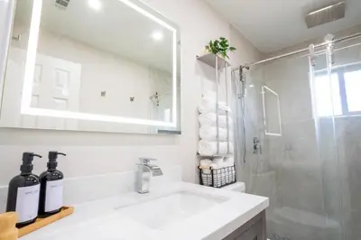 a white bathroom with a sink and a shower at Longwood Private Suite - Near Orlando - Modern, Private Entrance, Fast WiFi in Orlando