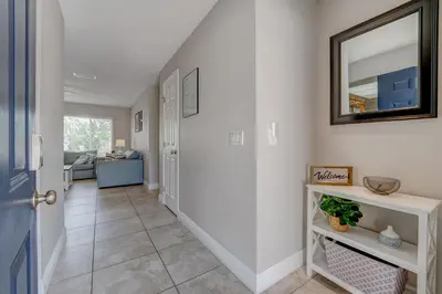 a hallway of a home with a door and a mirror at Spacious Casselberry House with Backyard Pool in Orlando