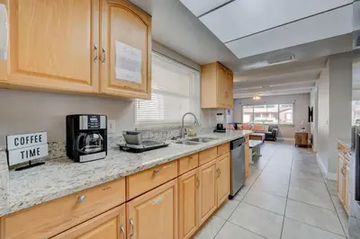 a kitchen with wooden cabinets and a counter top at Spacious Casselberry House with Backyard Pool in Orlando