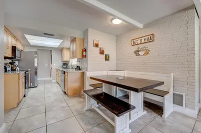 a kitchen with a table in the middle of it at Spacious Casselberry House with Backyard Pool in Orlando