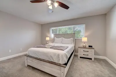 a bedroom with a large bed and a window at Spacious Casselberry House with Backyard Pool in Orlando