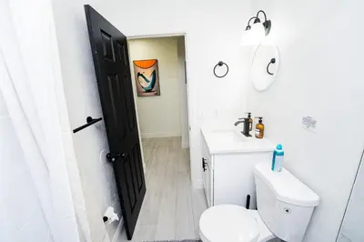 a bathroom with a white toilet and a sink at Close to the Action, Peaceful When You Return in Orlando