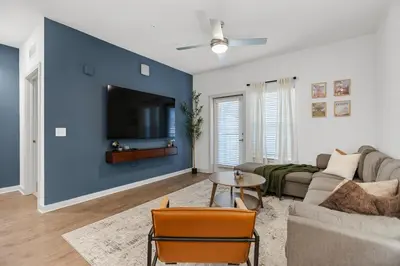 a living room with a couch and a tv at Magical Retreat Outside of Disney in Orlando