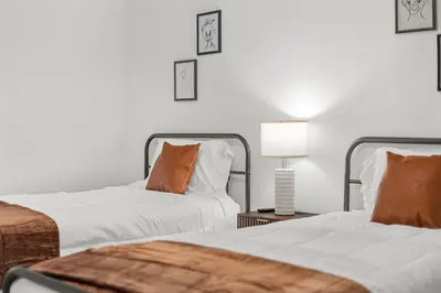 two beds sitting next to each other in a bedroom at Magical Retreat Outside of Disney in Orlando