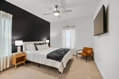 a bedroom with a bed and a black wall at Magical Retreat Outside of Disney in Orlando