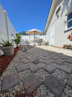 a patio with a table and chairs and an umbrella at Private 1 Bedroom Suite Near Orlando Attractions in Orlando