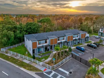 an aerial view of a building with a parking lot at Bright Modern Townhome Retreat in Kissimmee