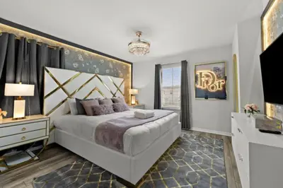 a bedroom with a large white bed and a window at New 2025 Bambi Orlando Pool Vacation Home in Clermont