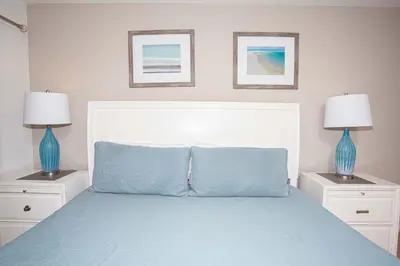 a bedroom with a bed with two blue lamps at Family Friendly 4 Bedrooms with GameRoom close to Disney in Compass Bay 5103 in Kissimmee