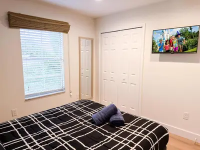 a bedroom with a bed and a tv on the wall at ER3047WOR - Cozy 3BD Townhome w/ Private Hot Tub in Kissimmee