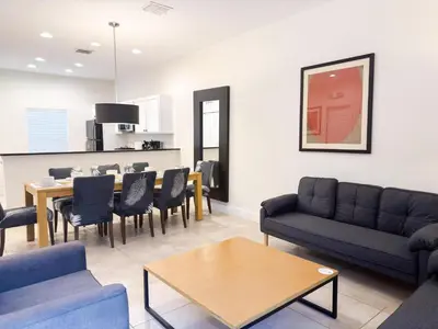 a living room with a couch and a table and chairs at ER3047WOR - Cozy 3BD Townhome w/ Private Hot Tub in Kissimmee