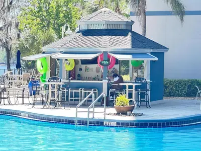 a bar next to a pool at a resort at BHBR207 - Condo Close to Disney - 1 mile in Orlando