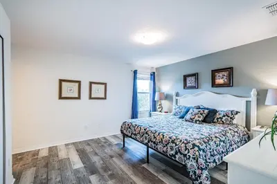 a bedroom with a bed and a window at Modern Pool Townhome Minutes to Disney in Kissimmee