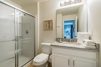 a bathroom with a shower and a toilet and a sink at Modern Pool Townhome Minutes to Disney in Kissimmee