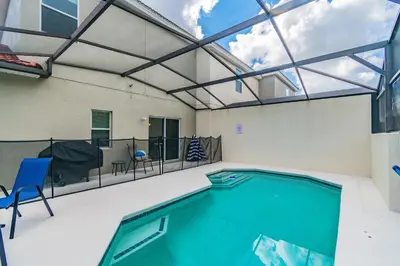 a indoor swimming pool with a glass ceiling at Modern Pool Townhome Minutes to Disney in Kissimmee