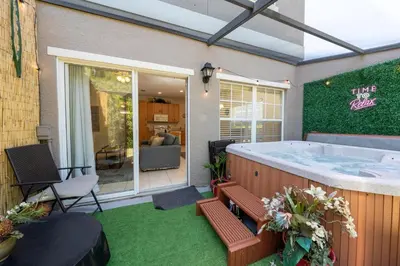 a large jacuzzi tub in a yard with a patio at Coral Cay Resort Your home away from home! in Kissimmee