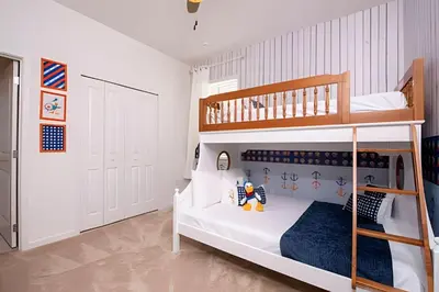 a childs bedroom with a bunk bed and a ladder at Casa c/ 9Q, piscina, spa e cinema! Perto da Disney in Kissimmee