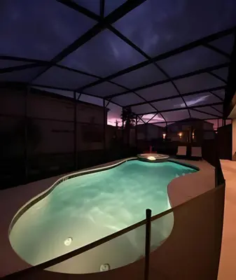 a swimming pool in a building at night at Casa c/ 9Q, piscina, spa e cinema! Perto da Disney in Kissimmee