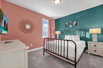 a bedroom with a bed and a wall with blue at Home With Private Pool, Theme & Game Room Near Disney With Resort & Waterpark Access - 7521Mr in Orlando