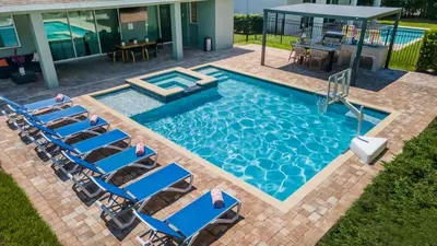 an overhead view of a swimming pool with chairs and a table at Incredible 8BR PetFriendly Encore Resort next to Disney - 7474 in Orlando