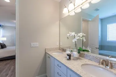 a bathroom with two sinks and a large mirror at Incredible 8BR PetFriendly Encore Resort next to Disney - 7474 in Orlando