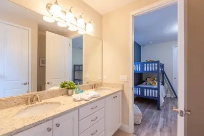 a bathroom with a sink and a large mirror at Incredible 8BR PetFriendly Encore Resort next to Disney - 7474 in Orlando