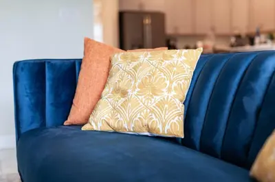 a blue couch with a pillow on it at Amazing 6BR at Storey Lake next to Disney - 2835 in Kissimmee
