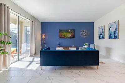 a blue living room with a blue wall at Amazing 6BR at Storey Lake next to Disney - 2835 in Kissimmee