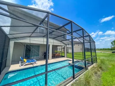 a glass house with a swimming pool at Amazing 6BR at Storey Lake next to Disney - 2835 in Kissimmee