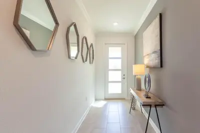 a hallway with a table and mirrors on the wall at Gorgeous 5BR at Storey Lake next to Disney - 2924 in Kissimmee