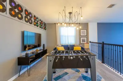 a living room with a couch and a chandelier at Gorgeous 5BR at Storey Lake next to Disney - 2924 in Kissimmee