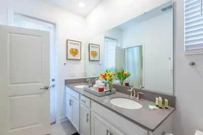 a bathroom with a sink and a large mirror at Gorgeous 5BR at Storey Lake next to Disney - 2924 in Kissimmee