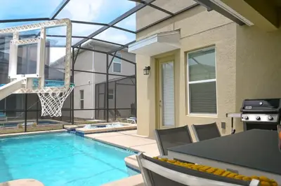a swimming pool with a basketball hoop in a house at Gorgeous 5BR at Storey Lake next to Disney - 2924 in Kissimmee