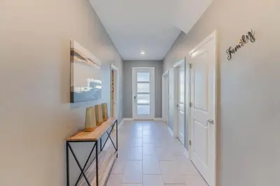 a hallway of a home with a table and a hallway at Gorgeous 6BR at Storey Lake next to Disney - 2850 in Kissimmee