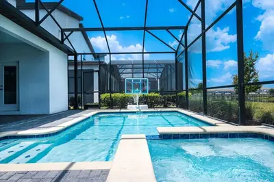 a swimming pool in a building with a large window at Stunning 6BR Lakeview at Storey Lake next to Disney - 2929 in Kissimmee